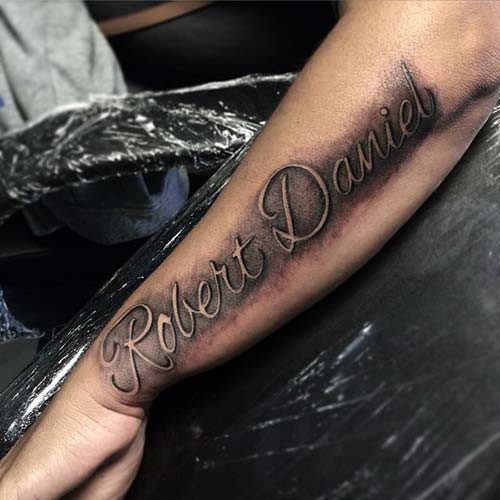 man forearm name tattoo