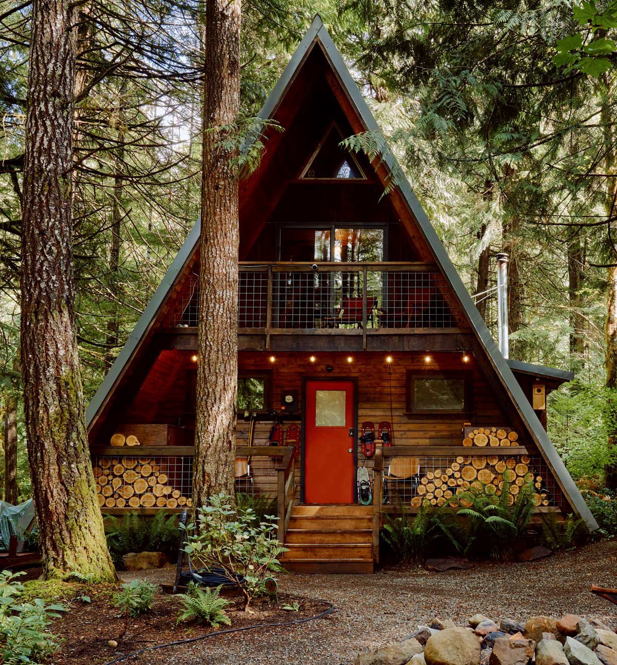 An A-frame house surrounded by pine trees in Washington state.
