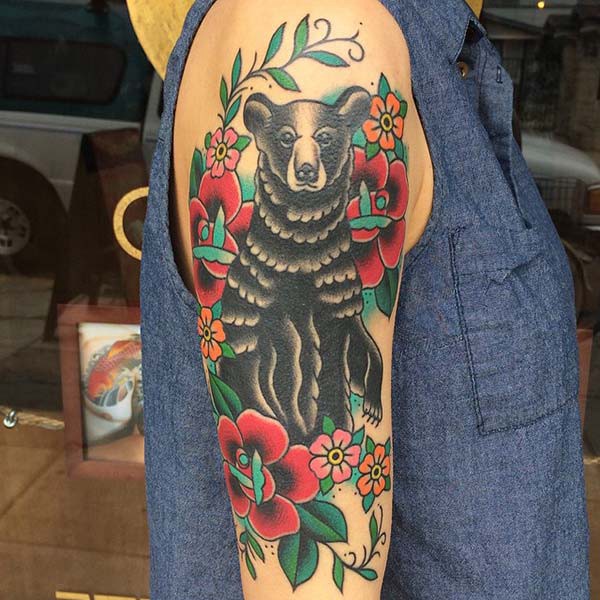 woman arm bear tattoo