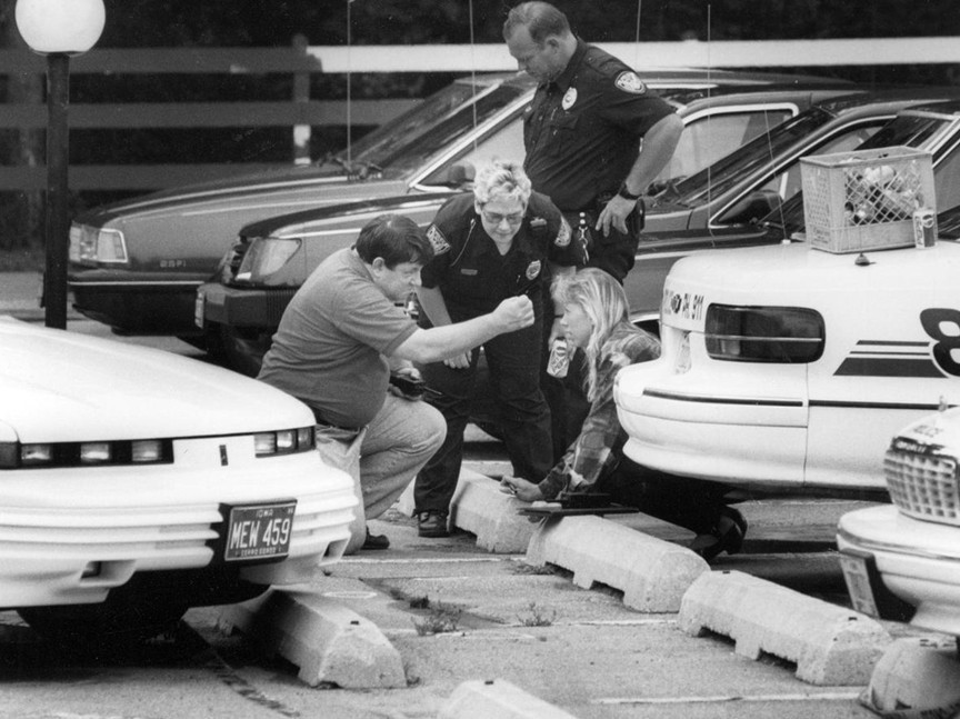 Investigators examine the parking lot where Jodi Huisentruit vanished in Mason City, Iowa in 1995.