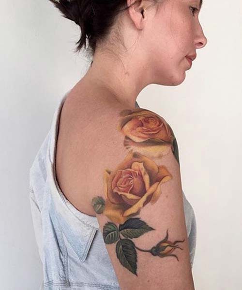 yellow rose woman shoulder tattoos