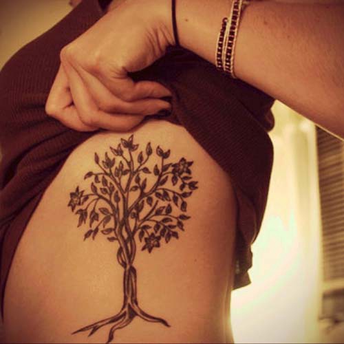 woman belly tree tattoo